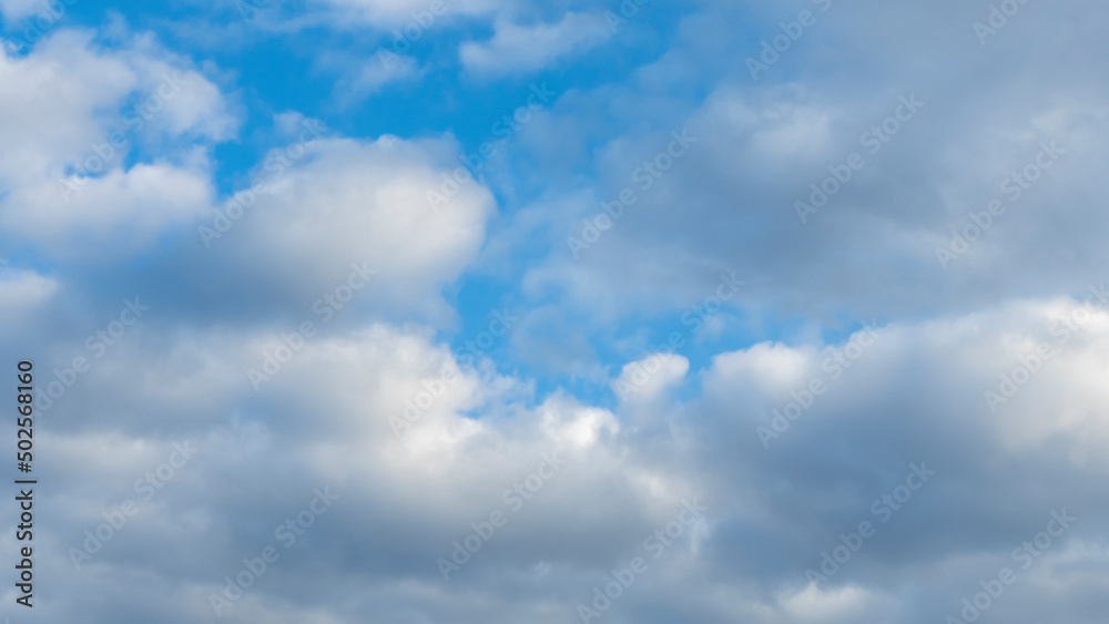 Blue sky background with clouds. White cumulus clouds in blue sky. Cloudy weather, cloudscape, copy space. Space for text. Blue sky background with clouds. White cumulus clouds in blue sky. Cloudy weather, cloudscape, copy space. Space for text.