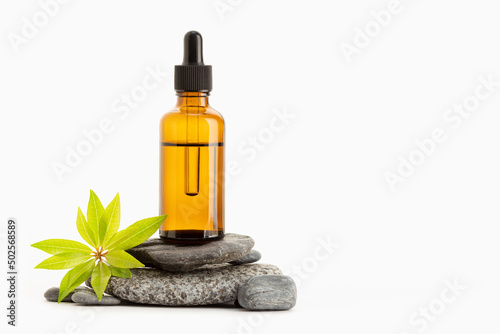 Herbal Essential oil on amber bottle isolated on white background. Copy space