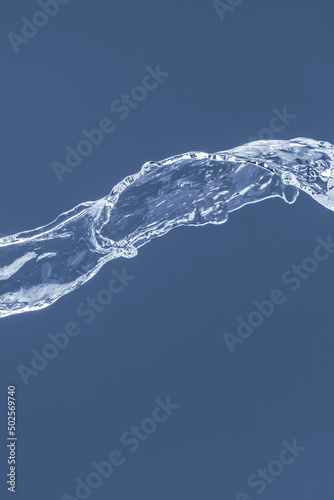 Water splash on a blue background. Reflection on the surface of the water.
