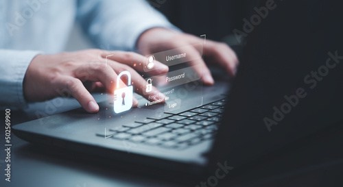 Businessman typing on keyboard laptop computer to input username and password for or technology security system and prevent hacker concept.