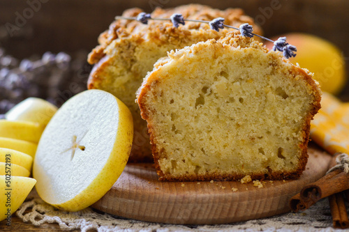 Cake in a cut. Garnished with pears and cinnamon sticks. Homemade baking. Wooden background.