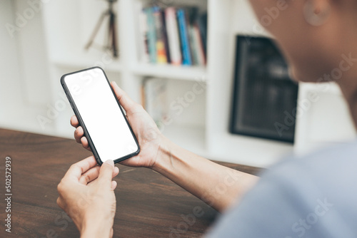 cell phone blank white screen mockup.hand holding texting using mobile on desk at office.background empty space for advertise.work people contact marketing business,technology