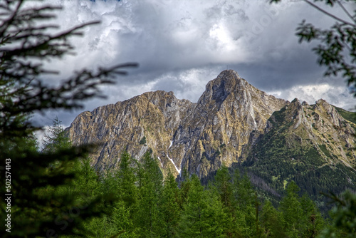 Tatra Mountains in summer, Giewont Mountain seen from Przysłup Miętusi against the cloudy sky. Tatry latem, Giewont widziany z przysłopu Miętusiego na tle zachmurzonego nieba.  © Mateusz