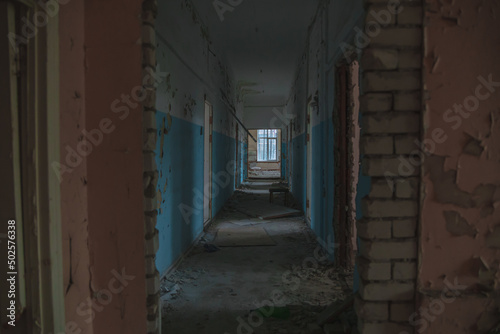  Abandoned building. A beautiful and scary corridor with shabby walls. Interior of an old abandoned building