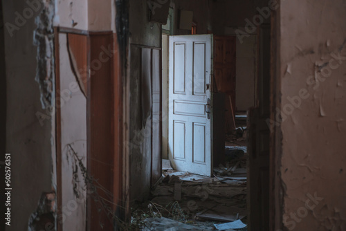  Abandoned building. A beautiful and scary corridor with shabby walls. Interior of an old abandoned building © Denis Chubchenko