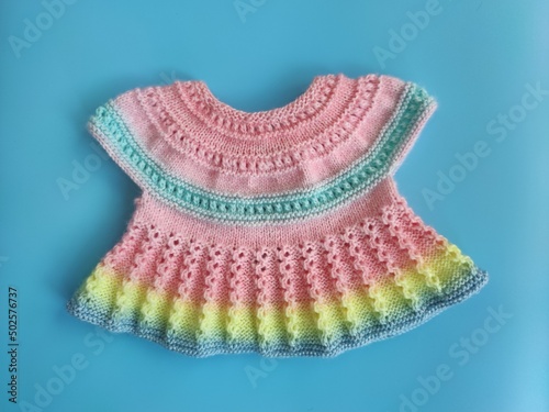 Colorful knitted dress for children. Baby clothes. Rainbow cute kid's jersey. Fashion for kids. Ideas for handmade