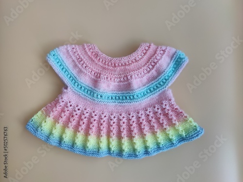 Colorful knitted dress for children. Baby clothes. Rainbow cute kid's jersey. Fashion for kids. Ideas for handmade