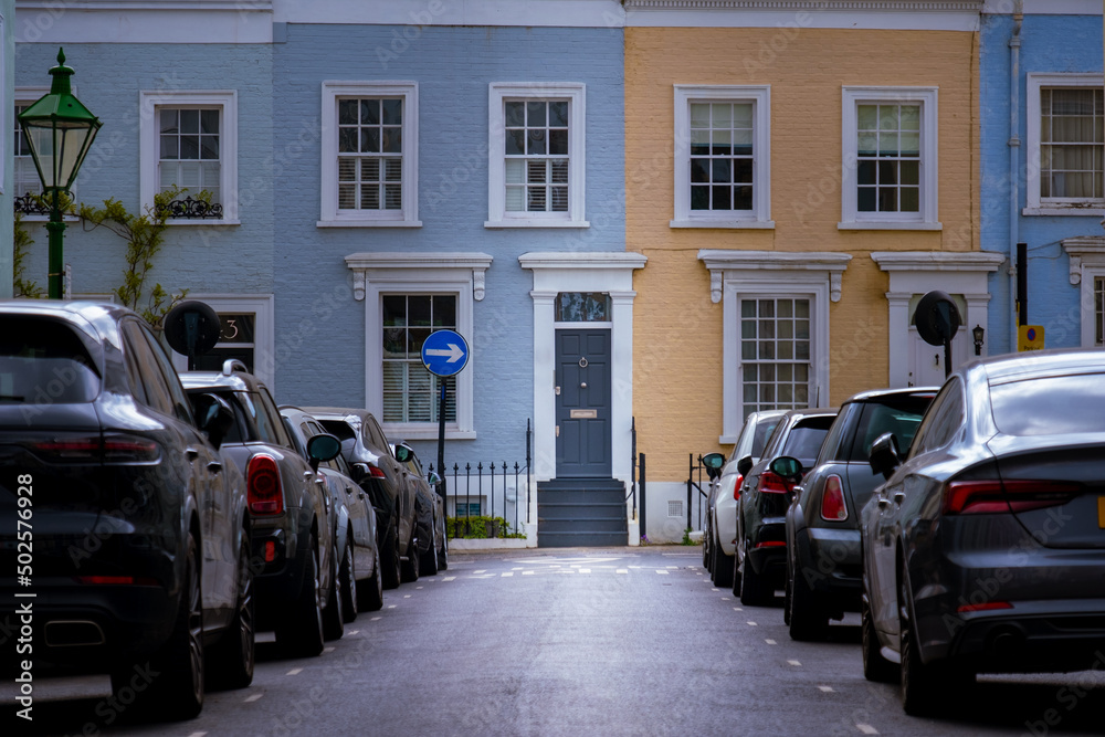 Colourful street of upmarket townhouses in Notting Hill area of West London