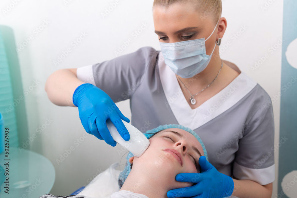 Young woman receiving electric galvanic anti-aging face spa massage at beauty salon. Young woman receiving electric galvanic anti-aging face spa massage at beauty salon.