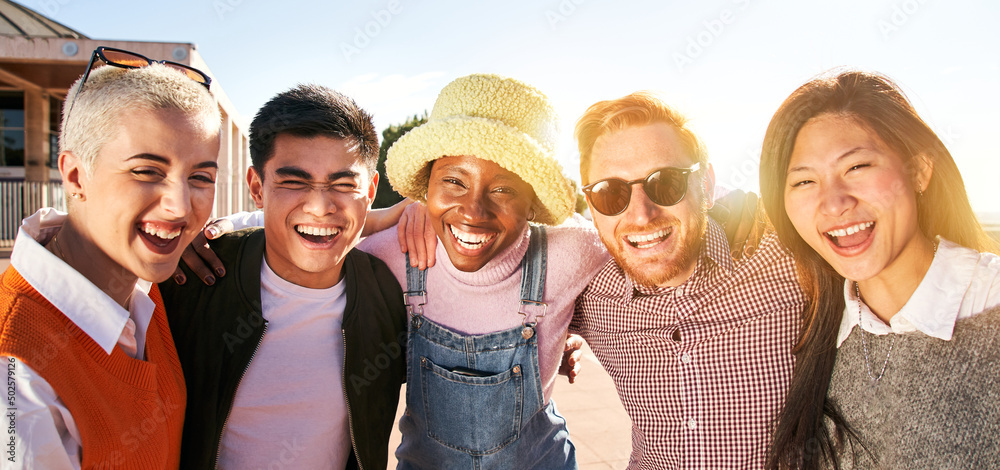 Smiling panoramic portrait of cheerful group of young people. Happy friends excited having fun. Interracial boys and girls taking picture looking at camera smart mobile phone. Enjoying vacations Smiling panoramic portrait of cheerful group of young people. Happy friends excited having fun. Interracial boys and girls taking picture looking at camera smart mobile phone. Enjoying vacations