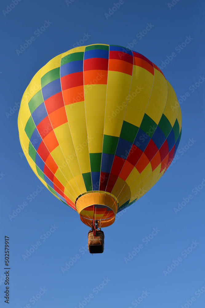 multi-colored hot air balloon close up in the blue sky multi-colored hot air balloon close up in the blue sky