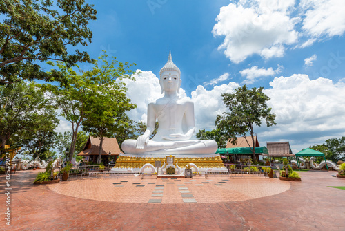 Big white Buddha image on the background with sky and clouds at Phu Sing mountain, Sahatsakhan District, Kalasin, Thailand photo