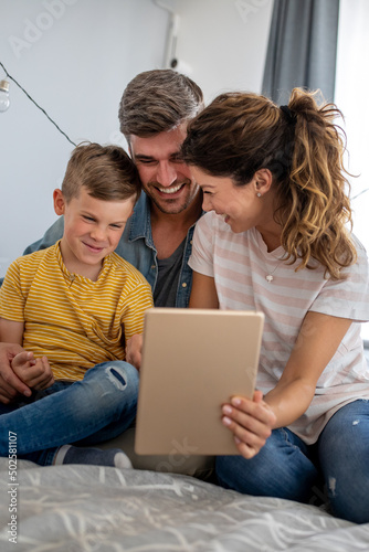 Happy modern family using computer together at home