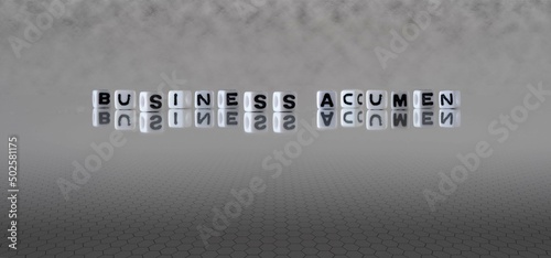 Photos business acumen word or concept represented by black and white letter cubes on a
