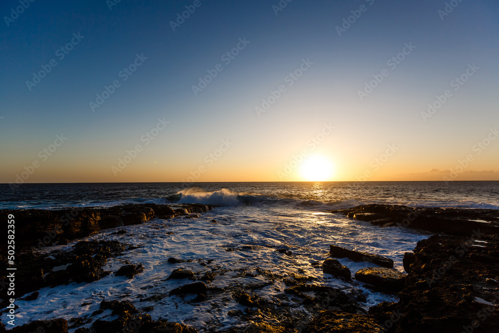 Evening scene on sea, stones, calm ocean