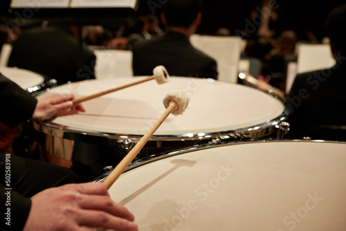 Close-up of hands playing timpani photo