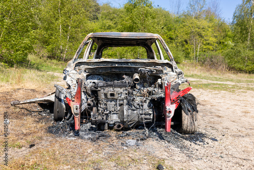 Newburn UK: 29th April 2022: A stolen car which has been burnt out and dumped in a field photo