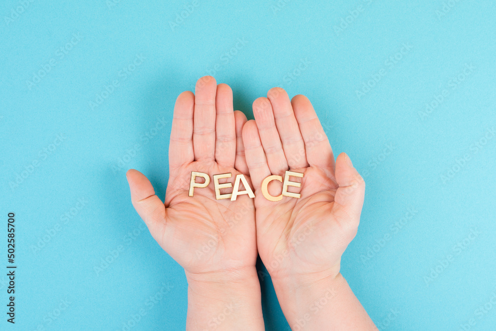 Holding the word peace in the hands, stop war, support Ukraine, living peaceful together Holding the word peace in the hands, stop war, support Ukraine, living peaceful together