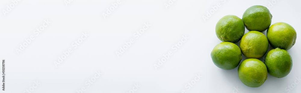 Top view of limes in round shape on white background with copy space, banner Top view of limes in round shape on white background with copy space, banner