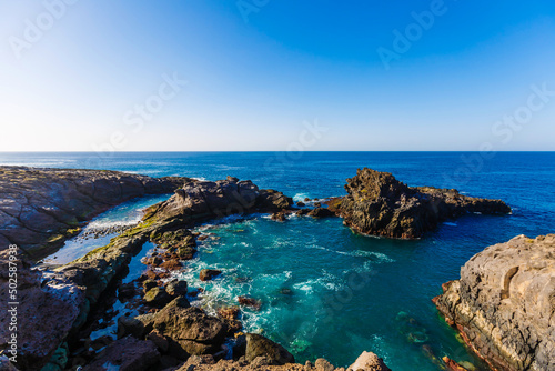 Evening scene on sea, stones, calm ocean