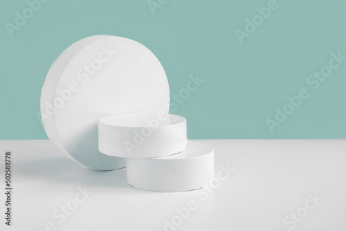 Podium for cosmetic product presentation. Abstract minimal geometrical form. Cylinder stone sphere tree forms, shadow. Trendy Scene. Front view. 3D photo