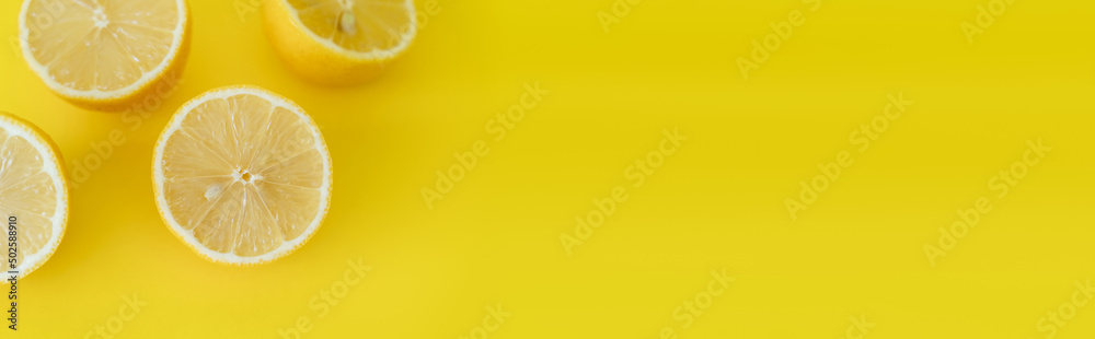 Top view of juicy halves of lemons on yellow background with copy space, banner Top view of juicy halves of lemons on yellow background with copy space, banner