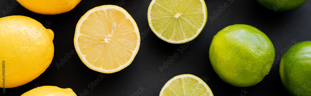 Top view of bright limes and lemons on black background, banner Top view of bright limes and lemons on black background, banner
