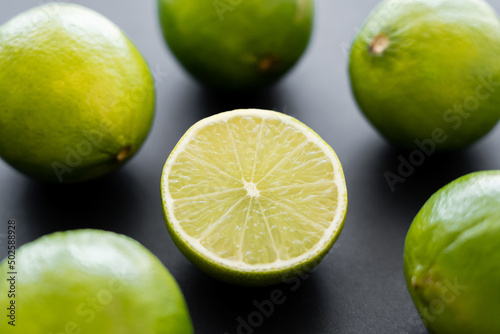 Fototapeta Naklejka Na Ścianę i Meble -  Close up view of half of lime on black background