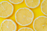 Top view of sliced lemon on yellow background