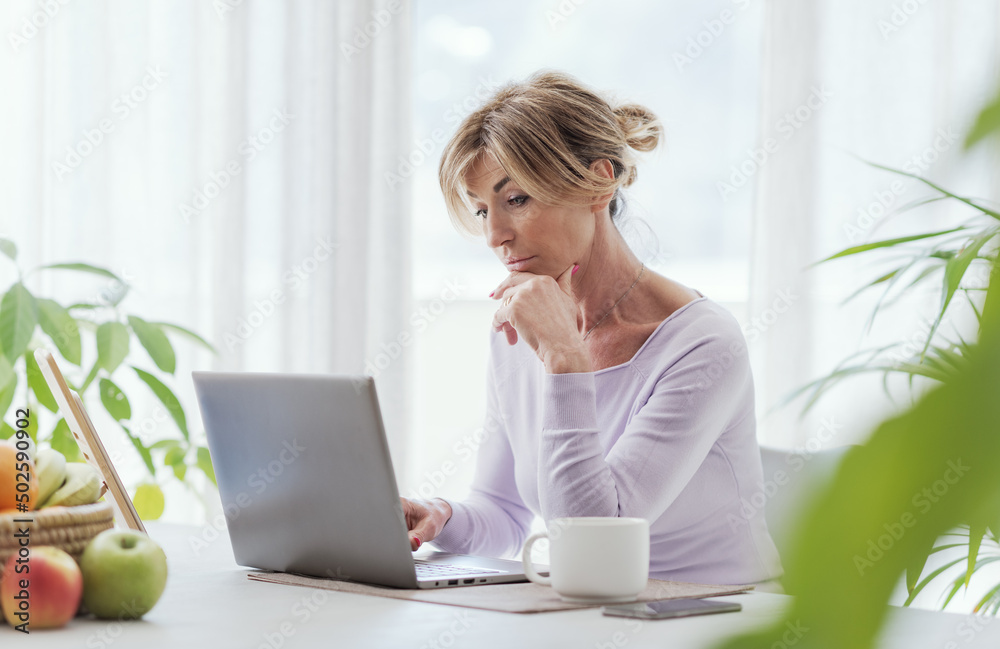 Mature woman working with her laptop Mature woman working with her laptop