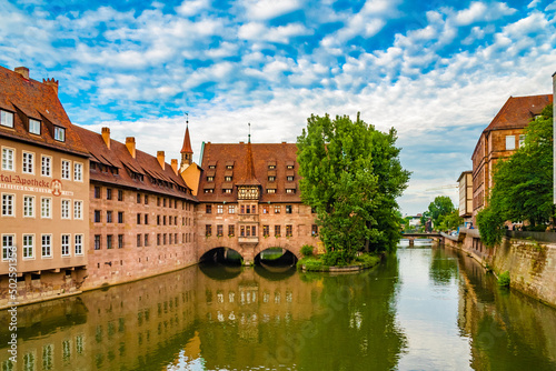 Lovely panoramic view of the Heilig-Geist-Spital (Holy Spirit Hospital) from the west, partly built over the Pegnitz river in Nürnberg, Germany. It now serves as a restaurant and senior home.