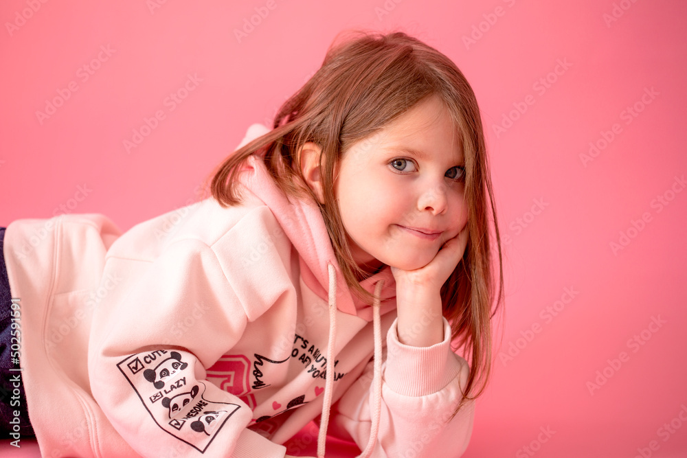 portrait of a beautiful baby girl on a pink background. Emotions of a child portrait of a beautiful baby girl on a pink background. Emotions of a child