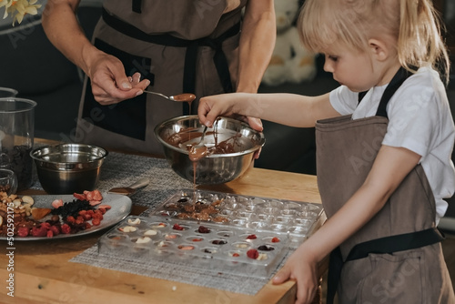 Mom and daughter make chocolate at home