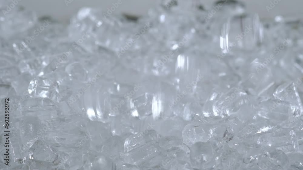 Close view of cold ice dropped down in green background Close view of cold ice dropped down in green background