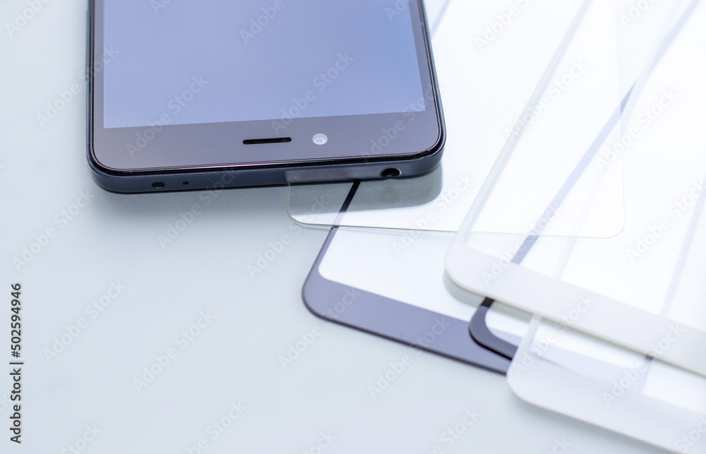 maintenance and repairing smartphones. many tempered glass screen protector and mobile phone, replace concept. mobile screen replacement protector, repair kit. installation of protective cover film maintenance and repairing smartphones. many tempered glass screen protector and mobile phone, replace concept. mobile screen replacement protector, repair kit. installation of protective cover film