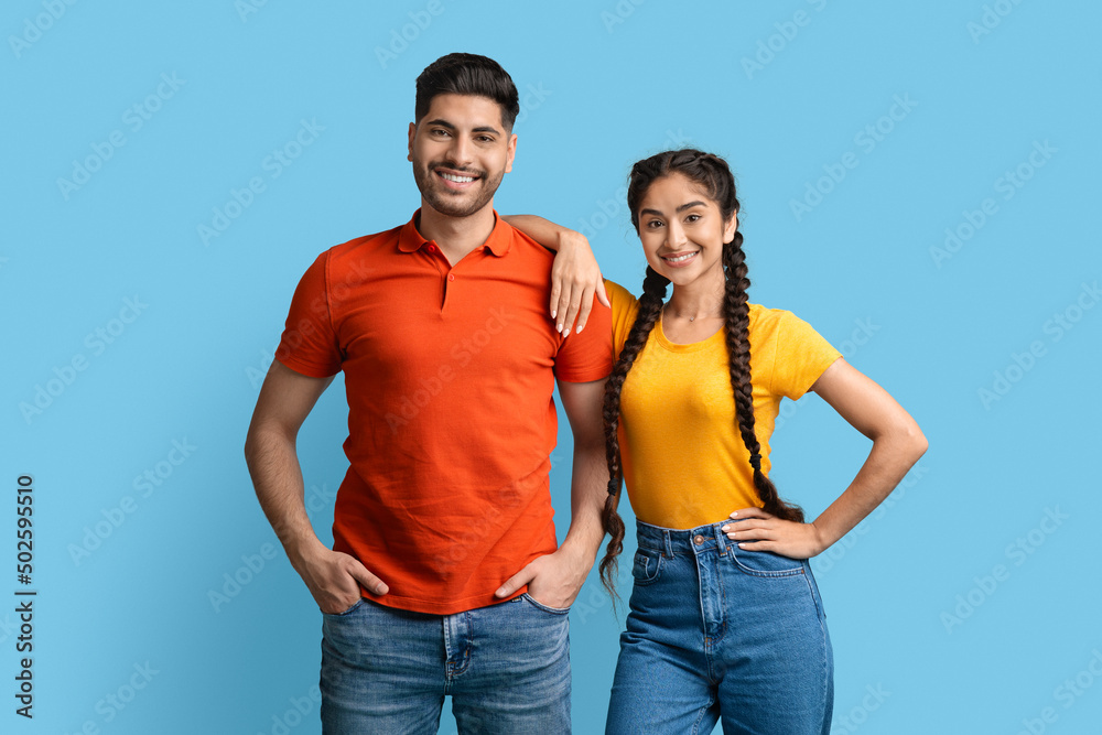 Obraz premium Portrait Of Attractive Young Arab Man And Woman Posing Over Blue Background,