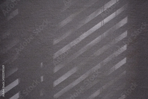 Top view flat lay background with organic shadows, bokeh, and texture on a lilac colored kraft paper background. Minimal summer lights and shadow concept.