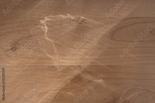 Top view flat lay background with organic shadows, light, bokeh, and texture on a wooden background. Minimal summer lights and shadow concept.