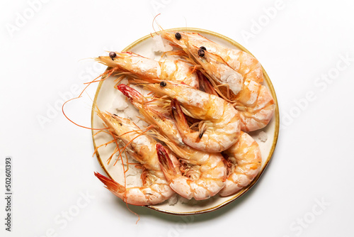 Baked salted banana shrimp (Penaeus merguiensis) usually serve with spicy sauce. Top view isolated on white background. photo