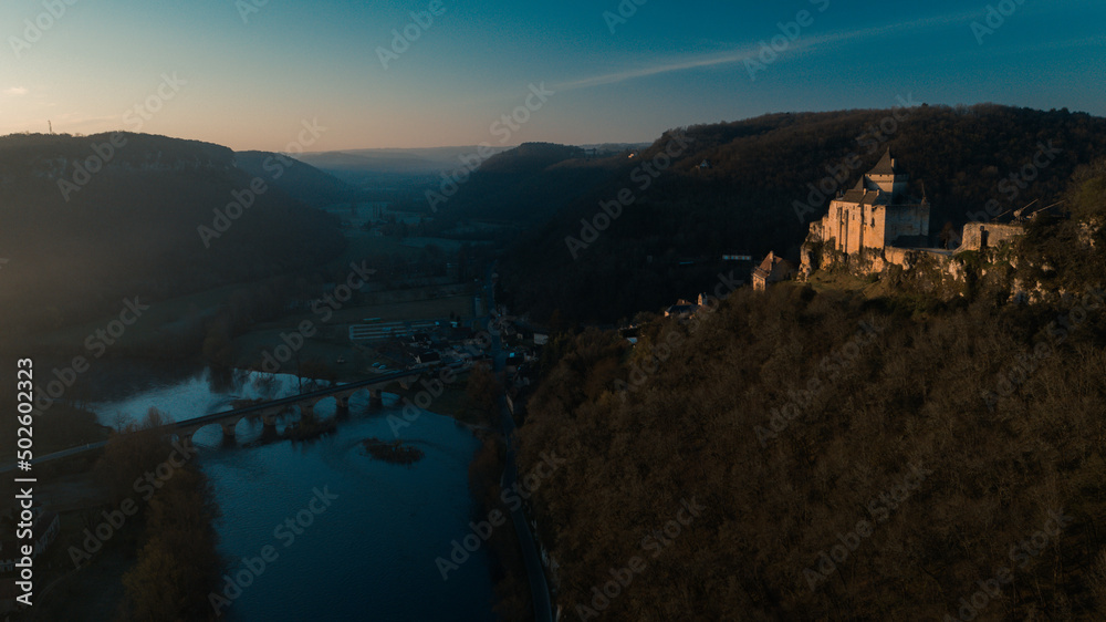 Dordogne valley drone shot at sunrise during blue hour, with Castelnaud castle