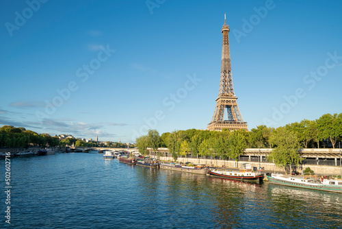 Modern district of skyscrapers on Seine with view on Eiffel Tower in Paris, France. Sunset timelapse with boats on Seine river. View from Mirabeau bridge. Modern buildings and The Statue of Liberty. © jirka