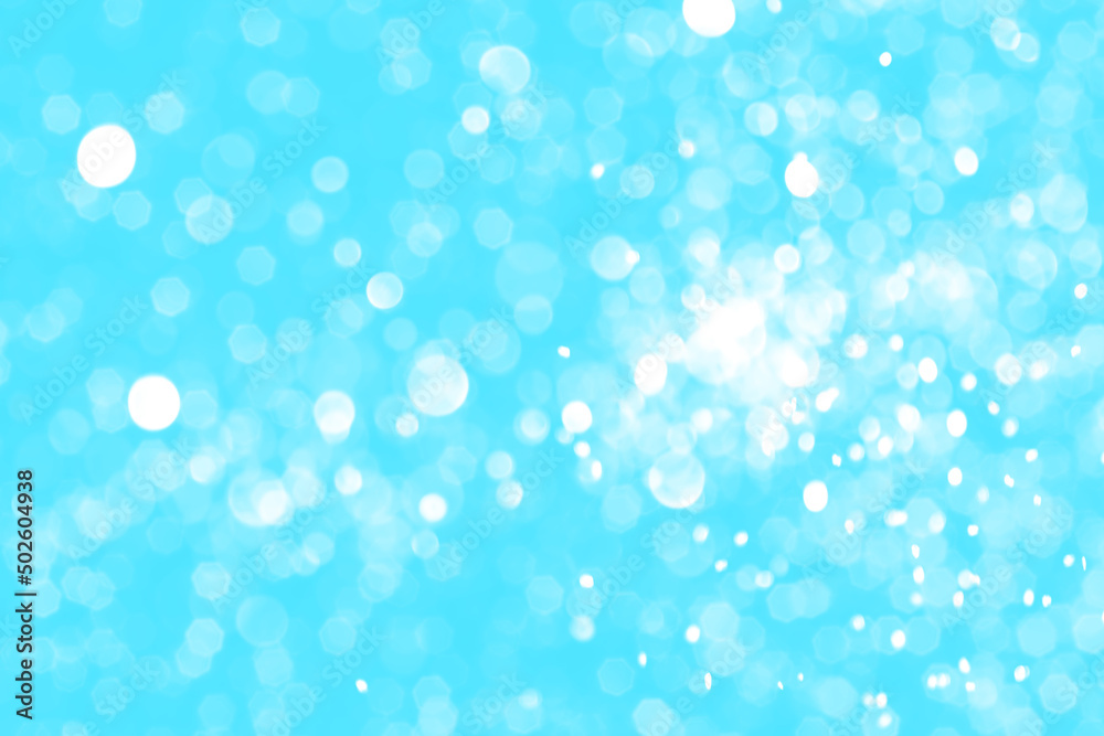 Bright blue sparkling glitter bokeh background, abstract defocused lights texture