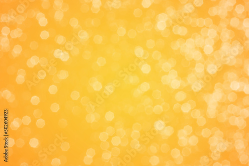 Summer orange sparkling glitter bokeh background, abstract defocused lights texture