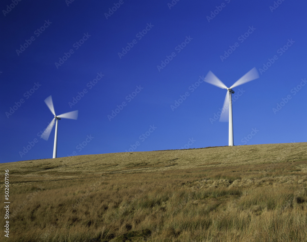 Low angle view of two wind turbines on a hill, Scotland Low angle view of two wind turbines on a hill, Scotland