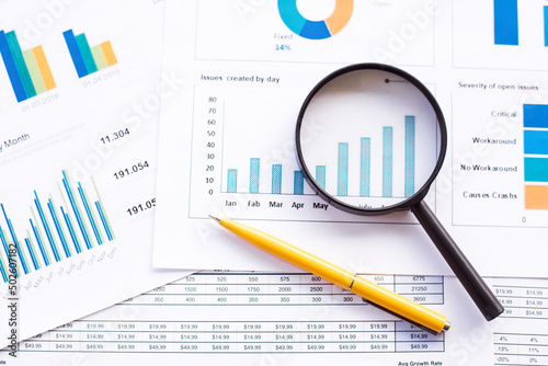 Magnifying glass and pen on charts graphs paper. Financial development, Banking Account, Statistics, Investment Analytic research data economy