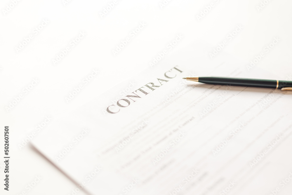 Green ballpoint pen on contract documets in office table Green ballpoint pen on contract documets in office table