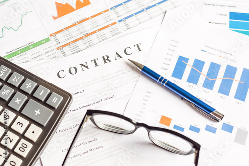 Close-up image of contract and charts form on a desk