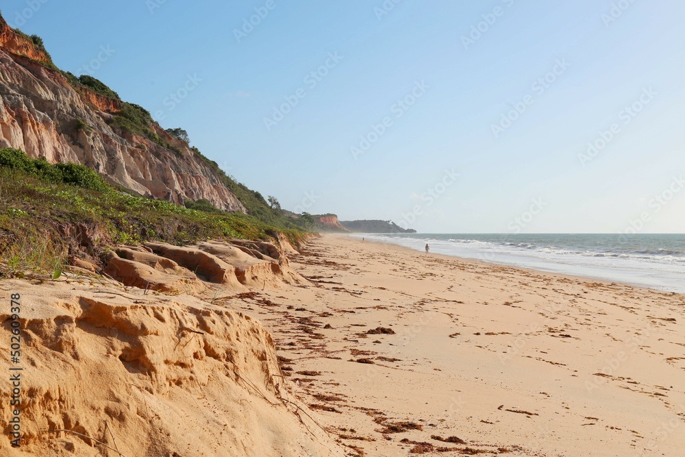 Orange cliff with land falling over the beach. Lots of orange sand and calm sea. Taipe Beach, Trancoso, Bahia, Brazil Orange cliff with land falling over the beach. Lots of orange sand and calm sea. Taipe Beach, Trancoso, Bahia, Brazil