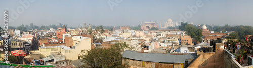 India, Agra, Panoramic view of chaos of guest houses, hotels and roof top restaurants of backpacker's enclave of Taj Ganj below South Gate of Taj Mahal photo