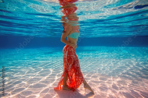 USA, Florida, Orlando, Young woman wading in pool photo